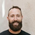 Friendly man with beard smiling outdoors, about Macon Sense.
