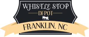 Historic Whistle Stop Depot in Franklin, NC, with vintage train signage.