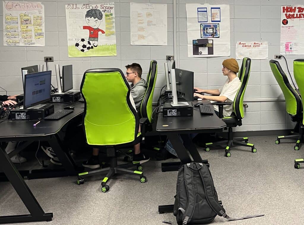 Students working on computers in a classroom setting.