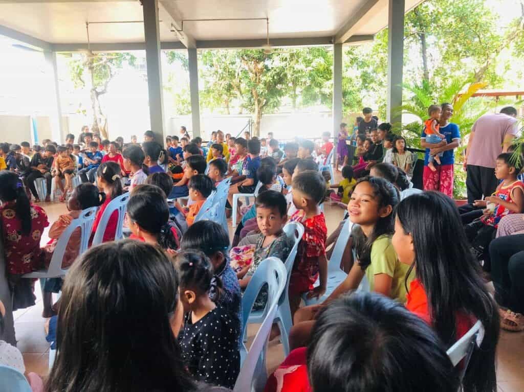 Children and families gather outdoors for a meaningful environmental and social initiative.