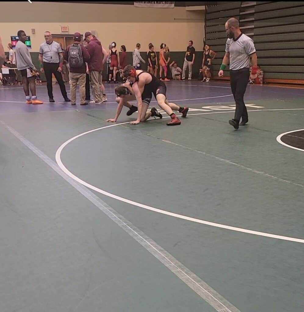Female wrestler on the mat during a wrestling match at Macon Sense event.