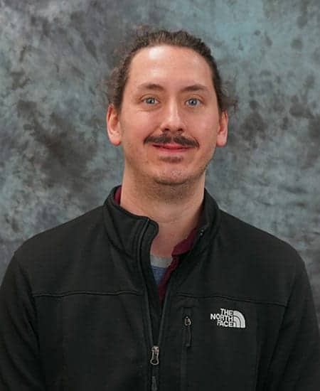 Portrait of Kimsey, town council member, stepping down, wearing North Face jacket.