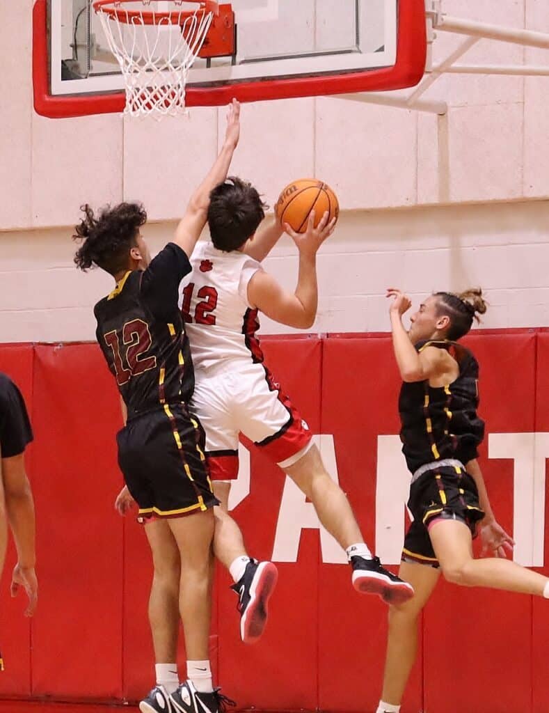 FHS basketball players competing fiercely during a game.