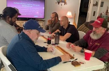 Group of people playing Cribbage at Macon Sense community event.
