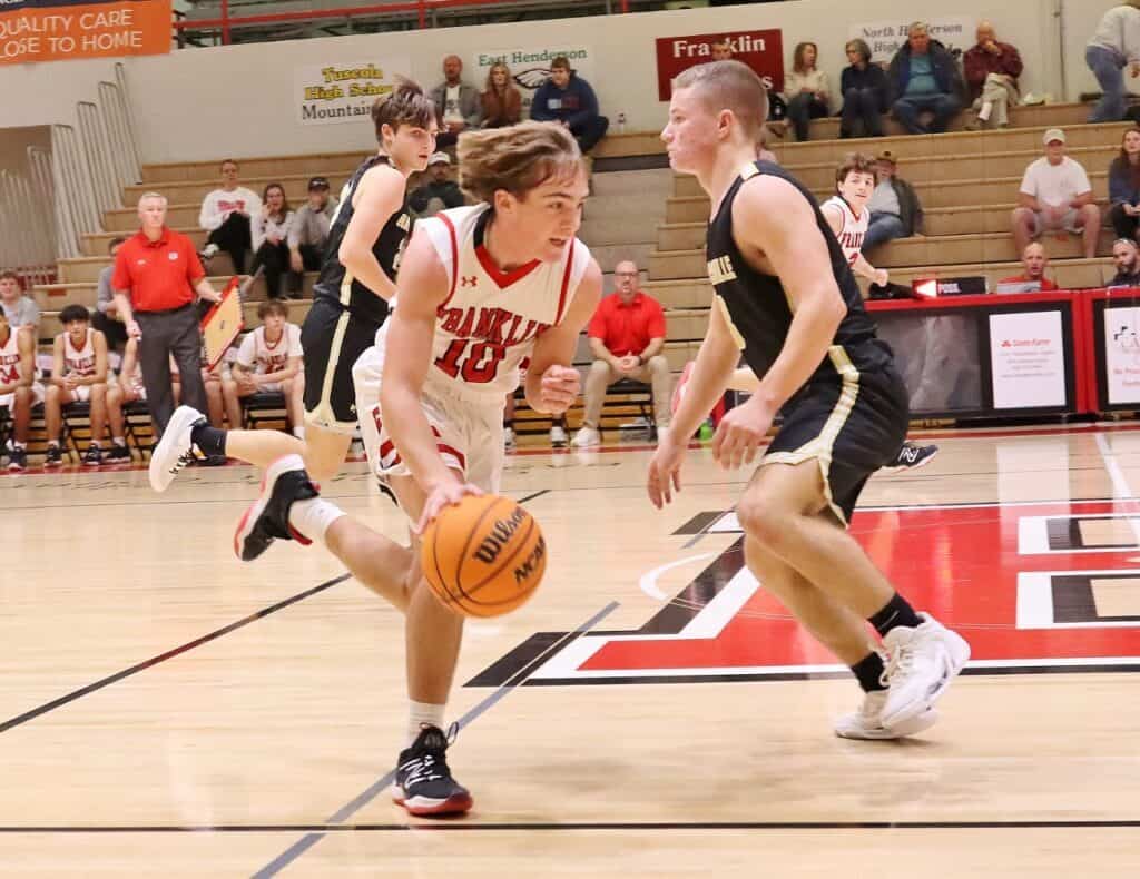 Youth basketball game with players competing fiercely on the court.