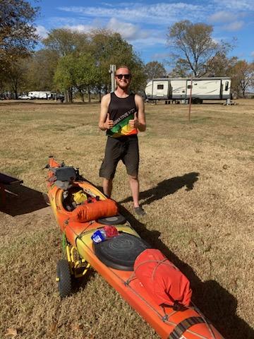 Kayaker with kayak and gear at Mississippi River challenge.
