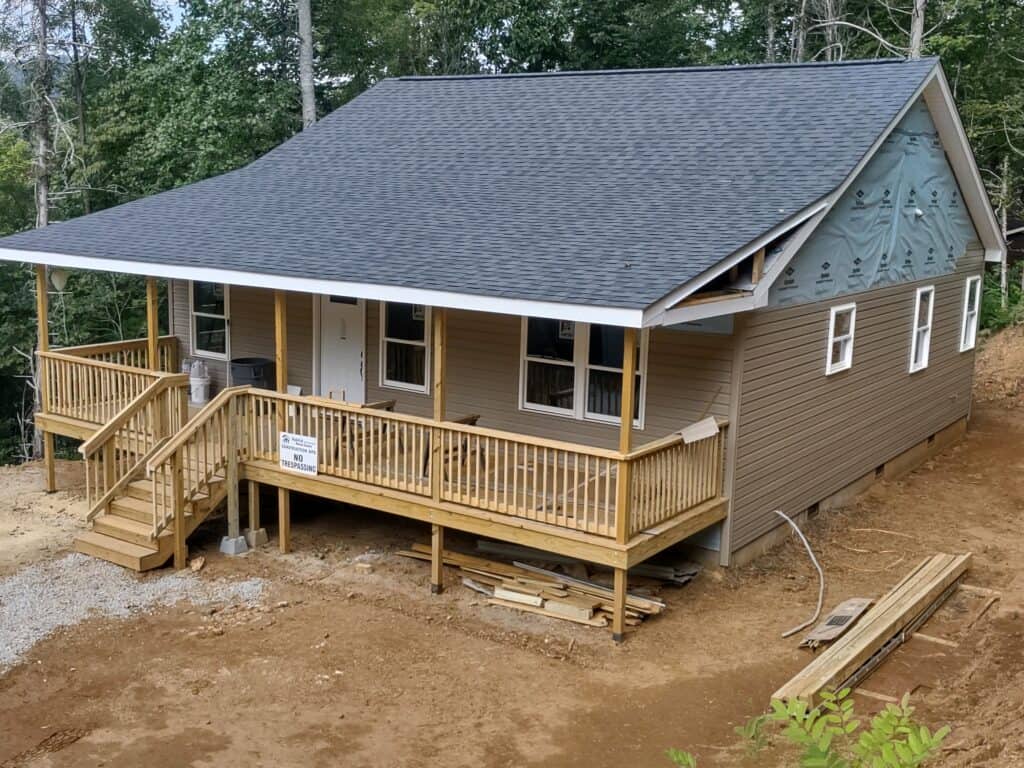 New small house with porch and wooden stairs in progress.