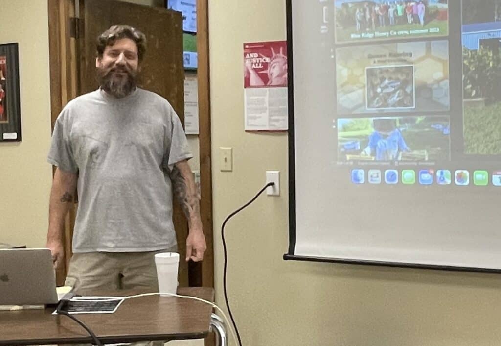 Beekeepers sharing knowledge during a community education event.