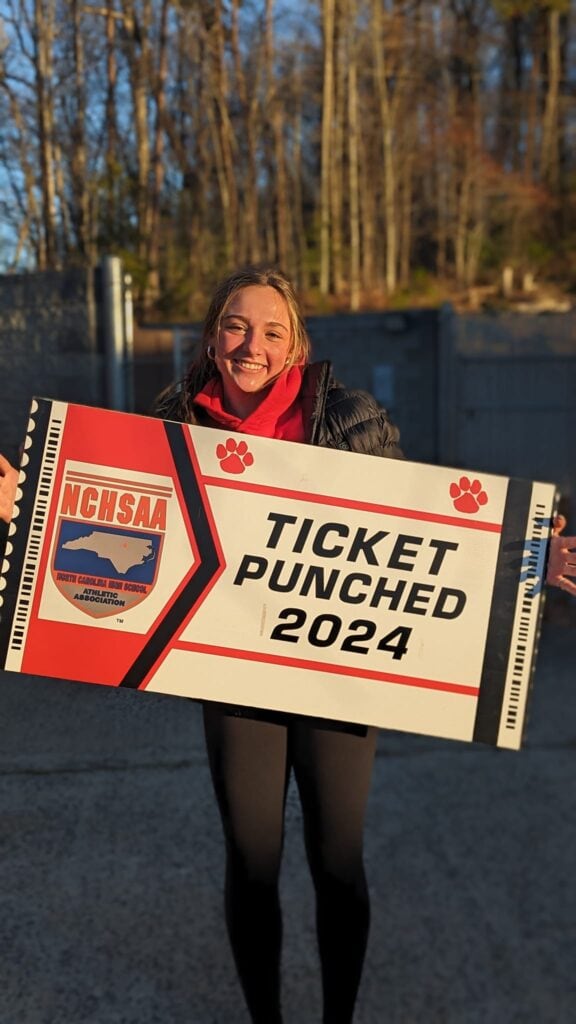 FHS athlete holding a ticket puncher for 3A indoor track championship.