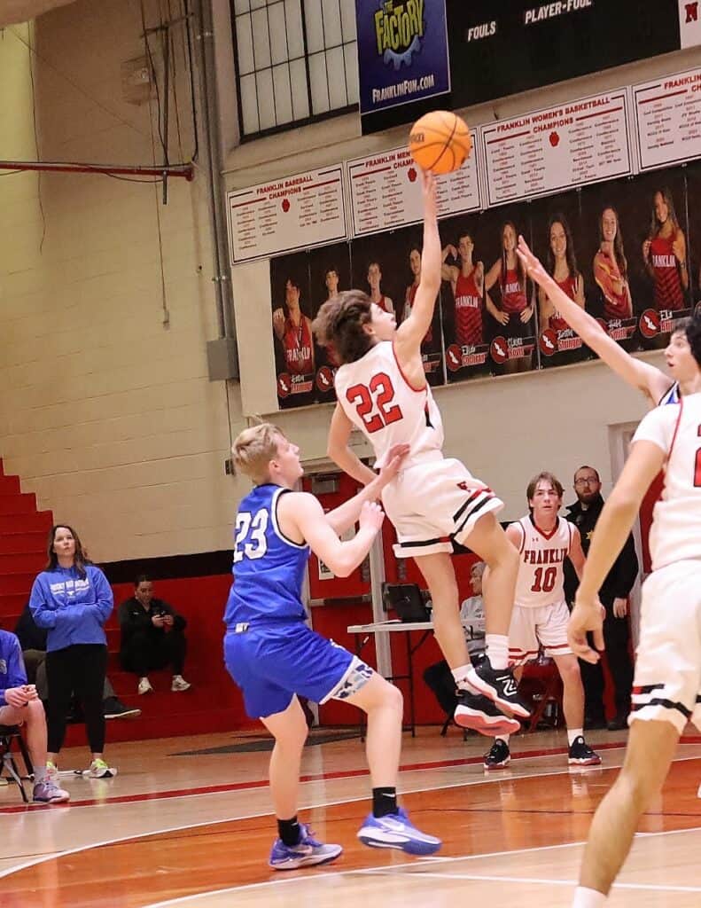 Junior varsity girls basketball player shooting during a game.
