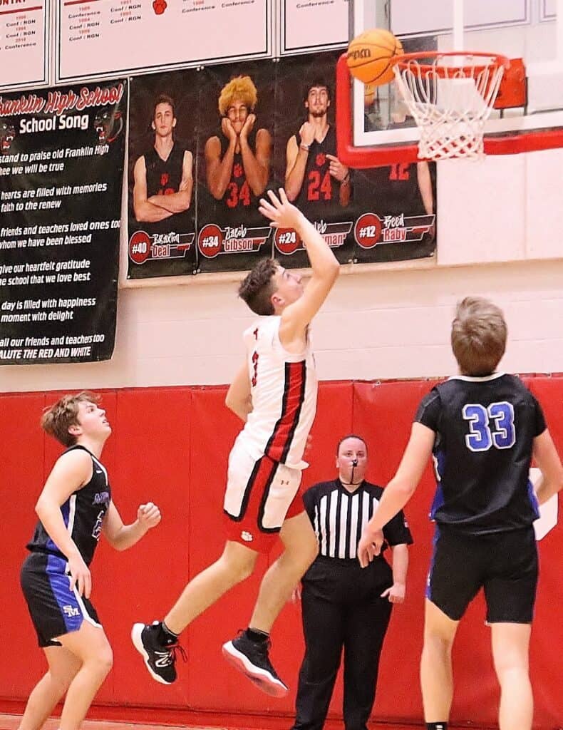 Young basketball player shooting a basket during a game at Macon Sense gym.