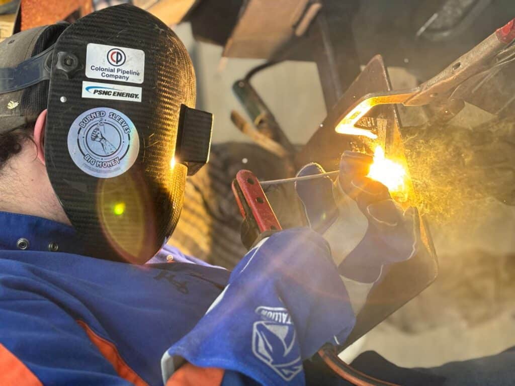Welding student practicing at Bartram Academy's transformative educational program.