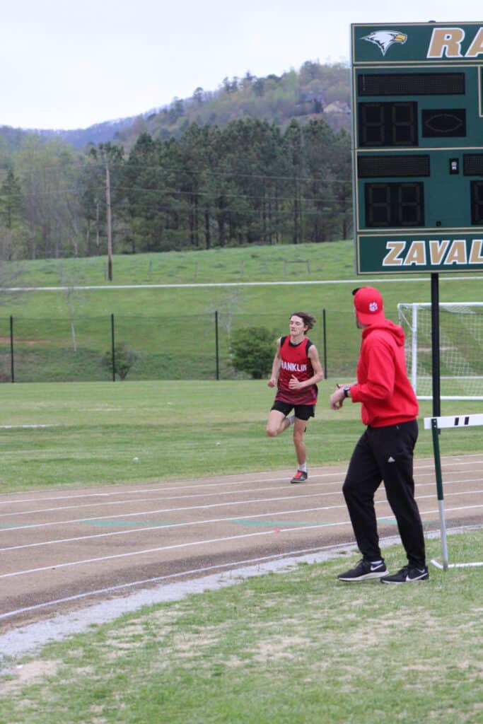 Coach Matt Harlfinger guiding FHS runners during track practice.