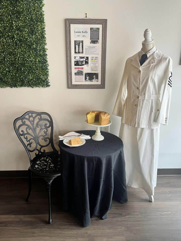 Sculpture unveiling honoring women of Macon County, featuring a display with a mannequin and framed.
