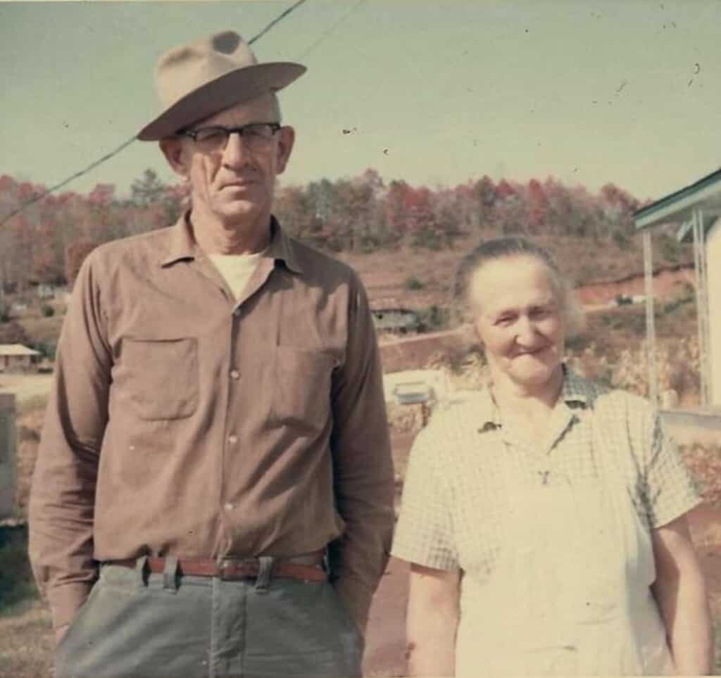 Vintage photo of an elderly man and woman outdoors, reflecting traditional foodways.
