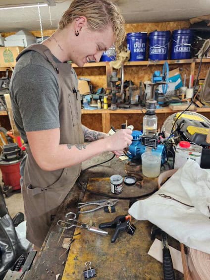 Handcrafting shoe soles in a workshop setting for better comfort and durability.
