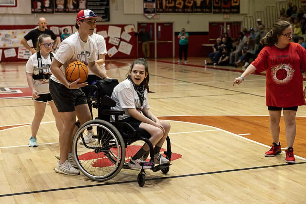 Inclusive wheelchair basketball game at FHS March Madness event.