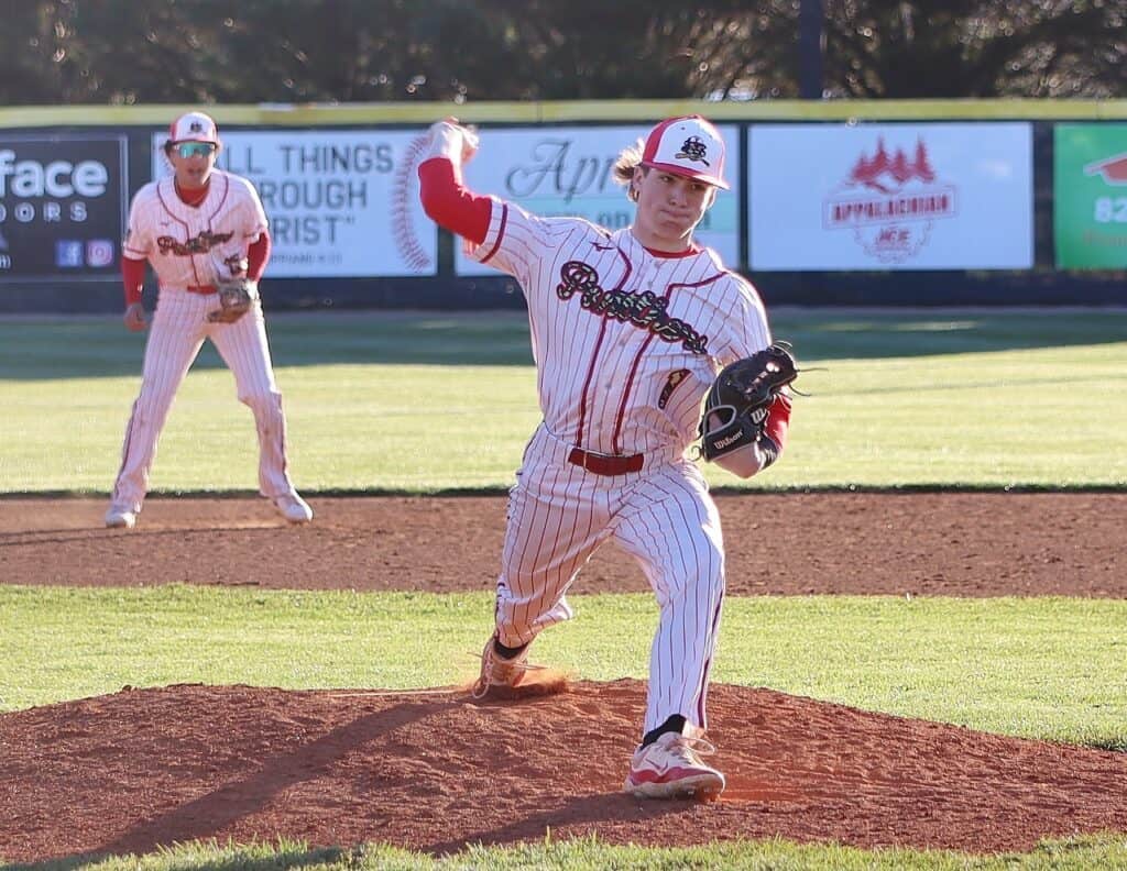 Young softball pitcher breaking records during a game at Macon Sense.