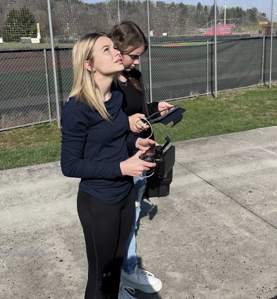 Two women operating drone controllers during training at Macon Sense.