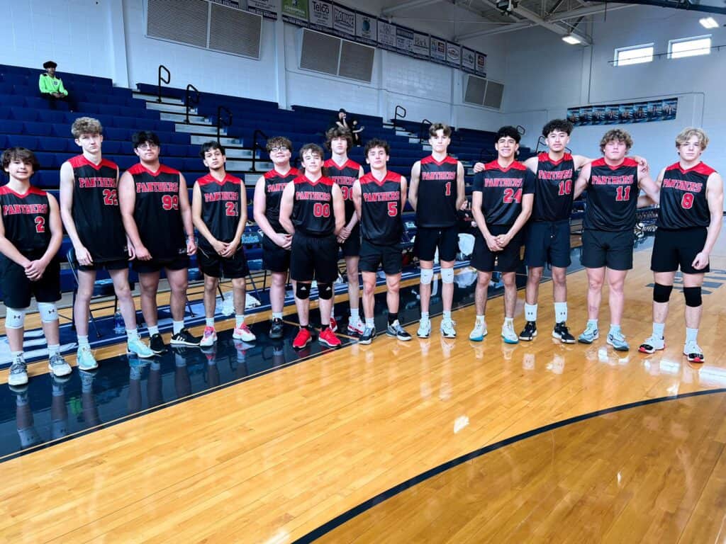 Macon Sense boys' volleyball team in gym, first season as club sport.