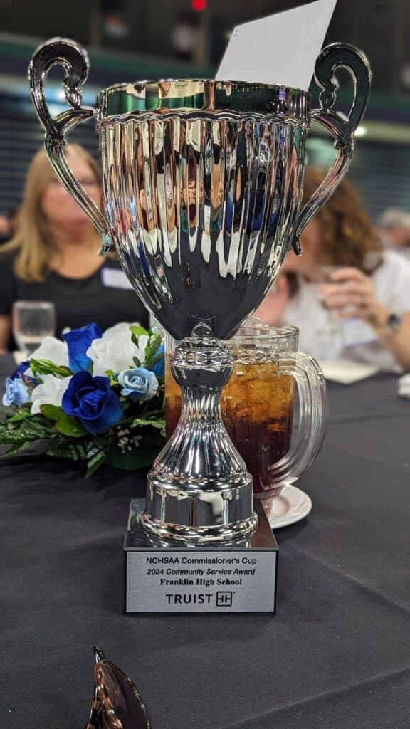 NCHSAA Champions Cup trophy at Macon Sense event, celebrating Franklin High School's success.
