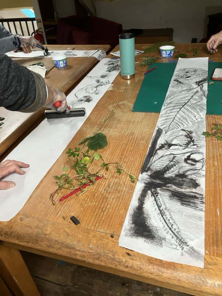 Art workshop with ink painting and nature-inspired designs in progress.