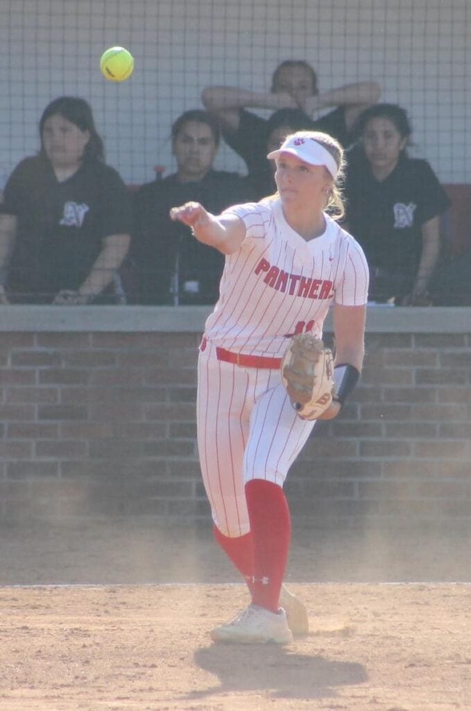 Female softball player pitching during a game at All State Softball event.