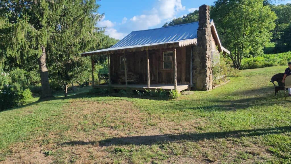 Rustic cabin in lush green landscape near Cartoogechaye, North Carolina.