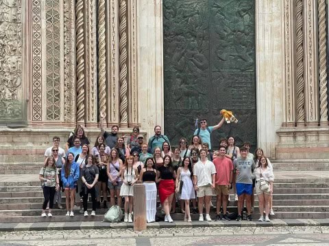 Group of FHS students visiting a historic monument in Europe.