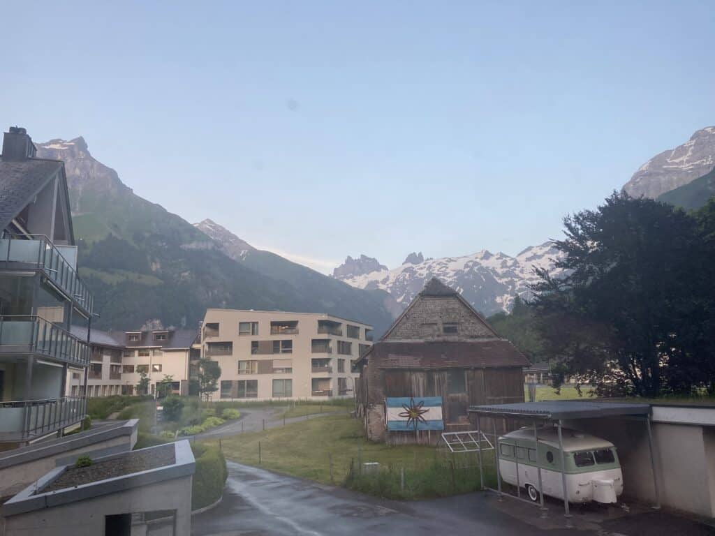 Mountain village with modern buildings and scenic mountain backdrop in the Alps.