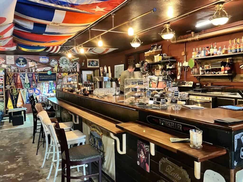Cozy bar interior at Rathskeller with flags and vintage decor.