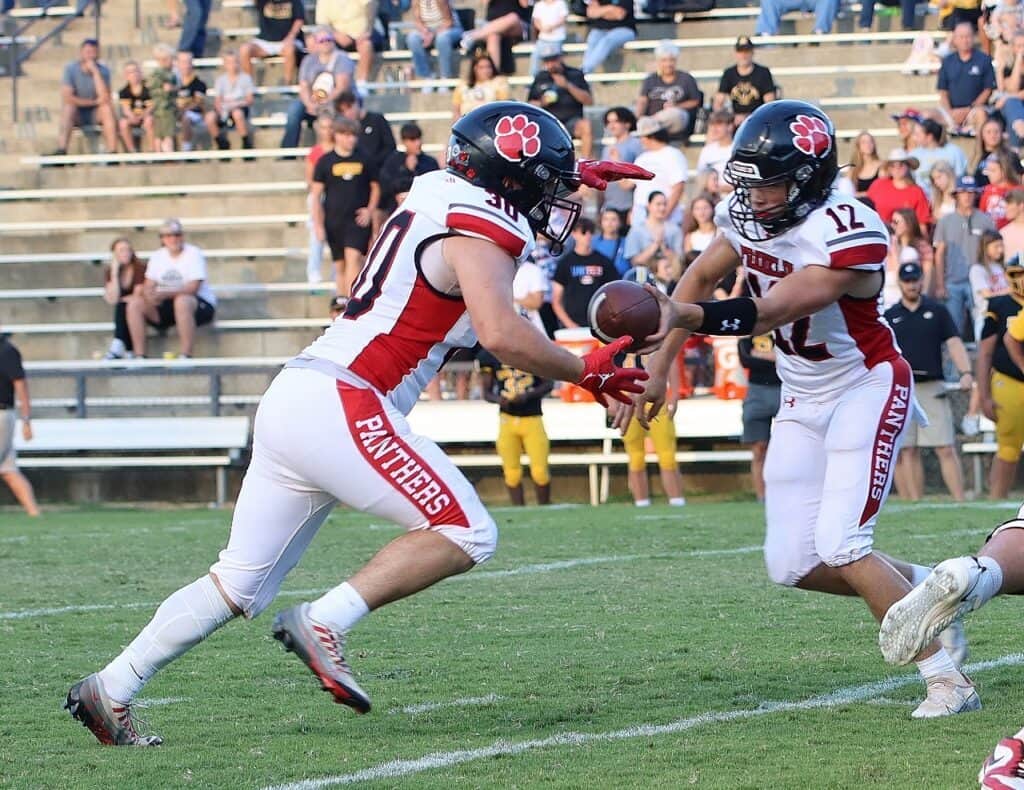 Football players in action during a game on the field.