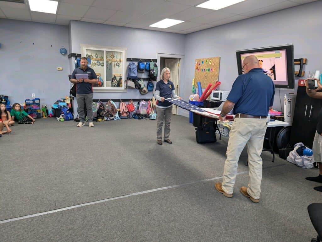 Students learning about American flag symbolism in a classroom setting.
