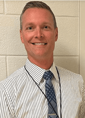 School official emphasizing the importance of words in preventing threats.