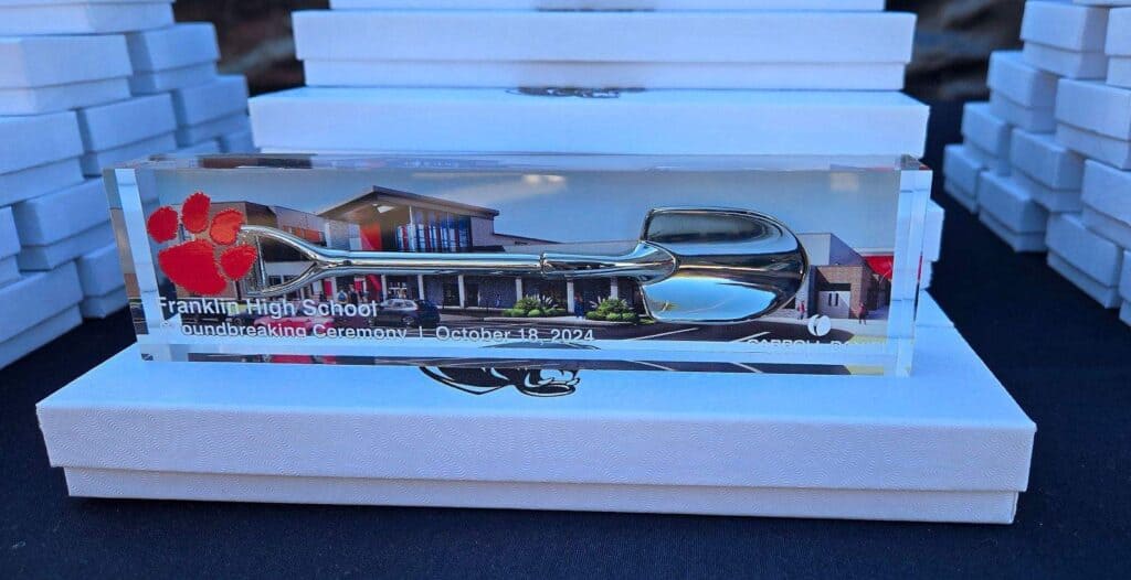 Glass award with "Franklin High School Groundbreaking Ceremony" inscription, scissors, and ribbon.
