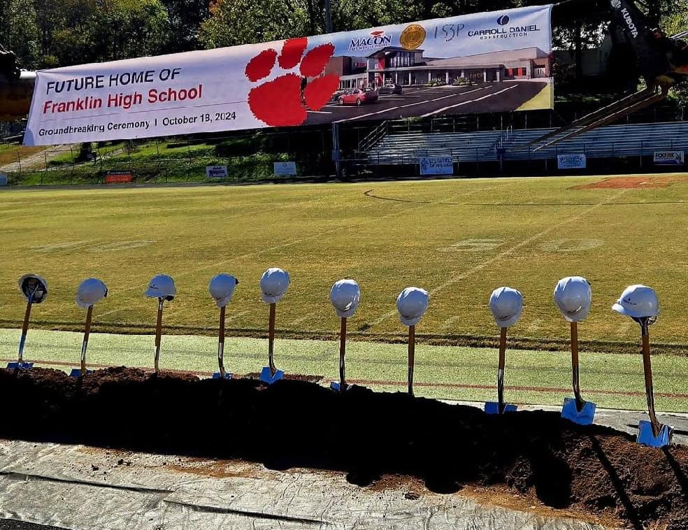 Groundbreaking event for Franklin High School with shovels and helmets ready.