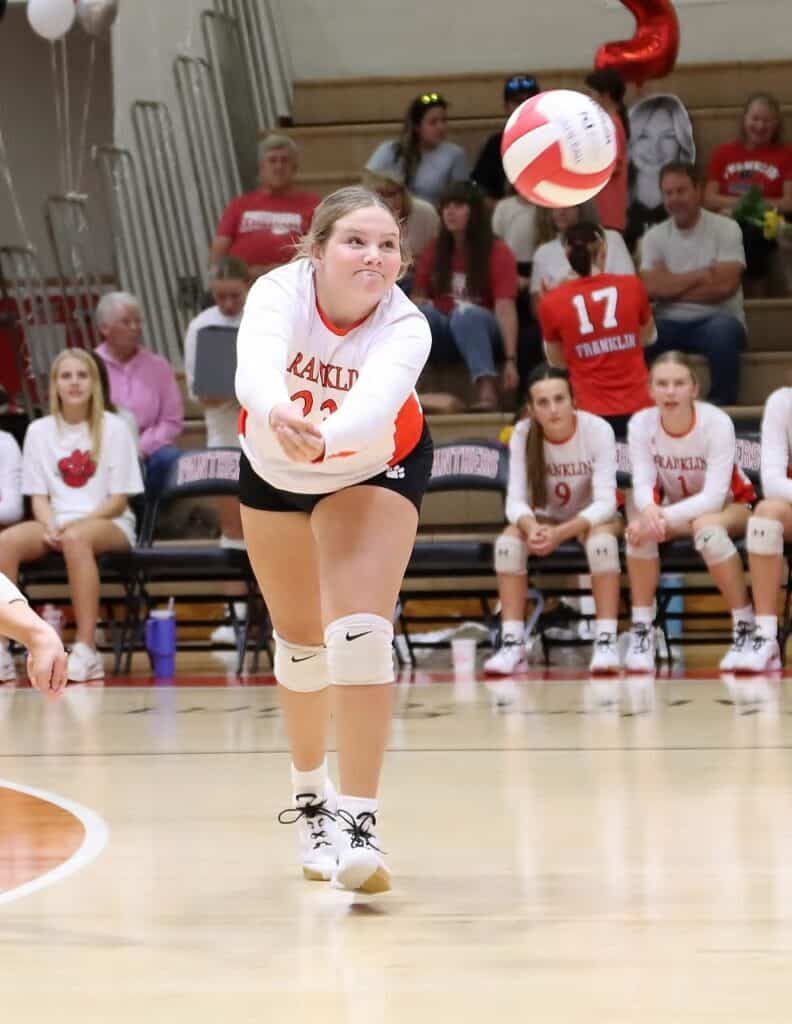 Female volleyball player serving during a match at FHS Panthers game.