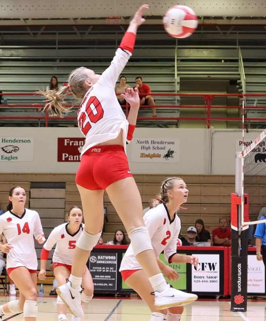 Female volleyball player in action during a game at North Henderson High School.