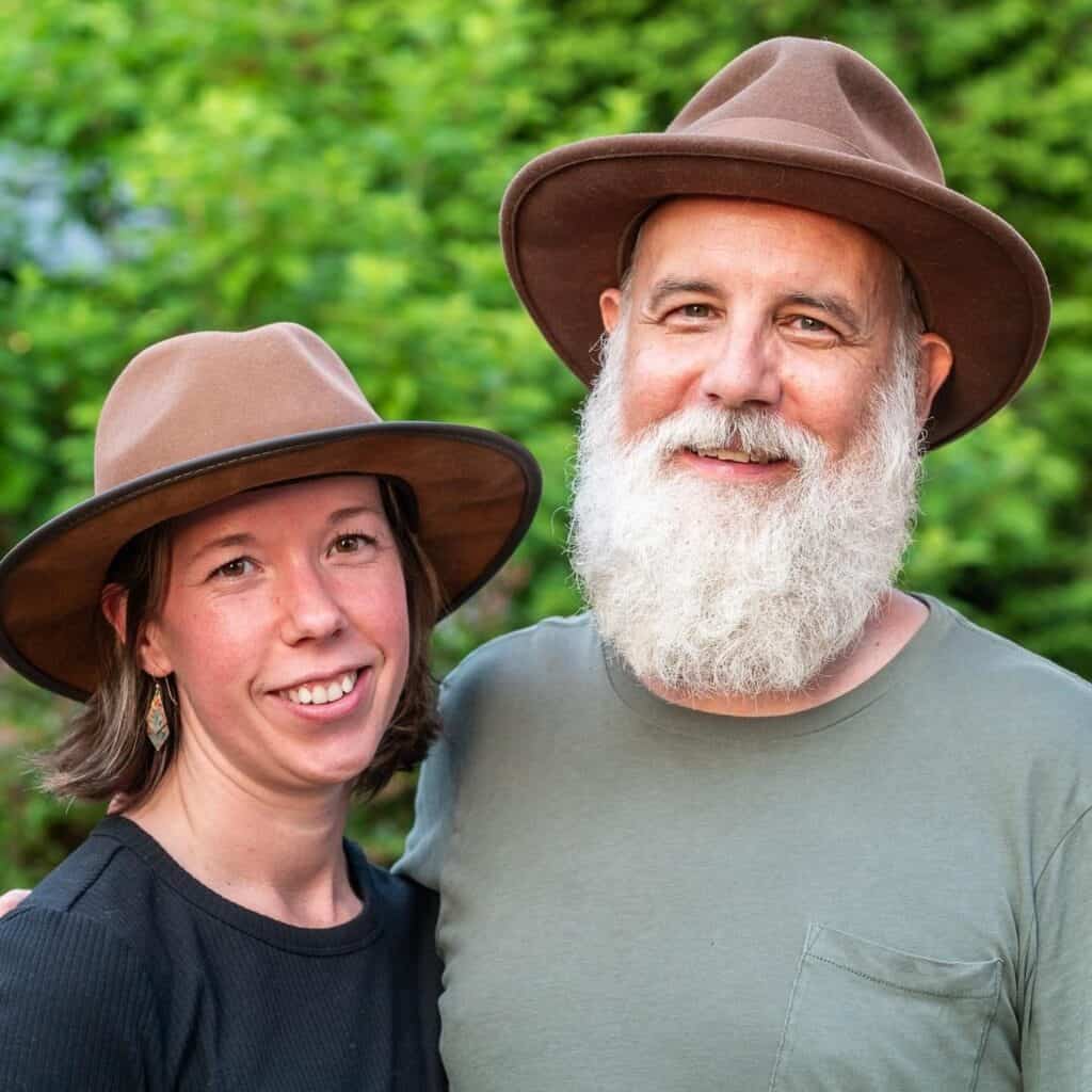 Two people wearing hats outdoors, symbolizing growth and purpose.