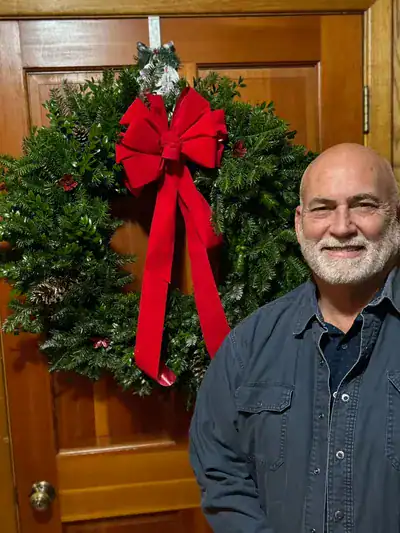 Festive Christmas wreath with red bow at Macon Sense event.