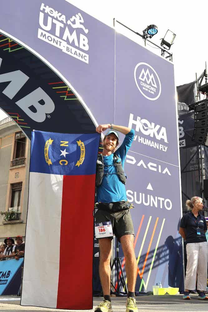 An ultra trail runner from Franklin stands proudly on the podium after completing a 100-mile race in.