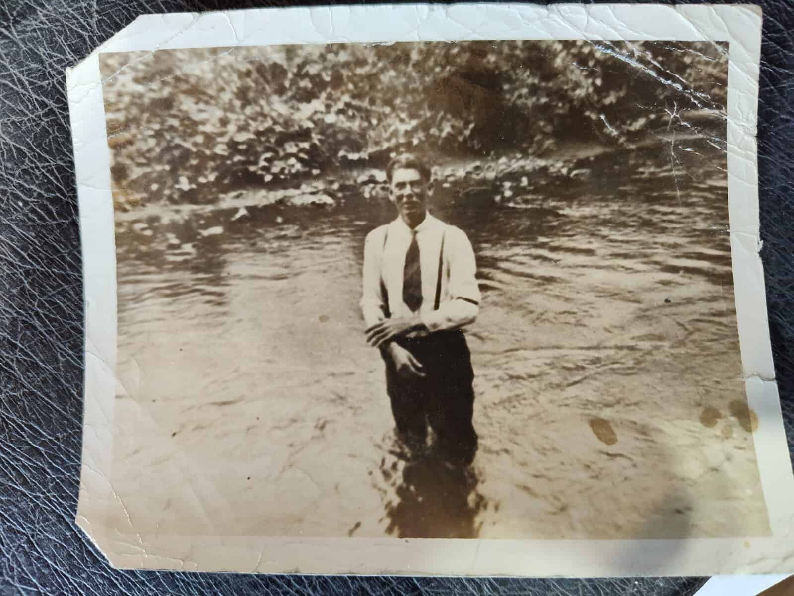 Historical photo of a Sorrells family member standing in a river.