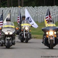 Patriot Guard Riders motorcycles at memorial honoring veterans.