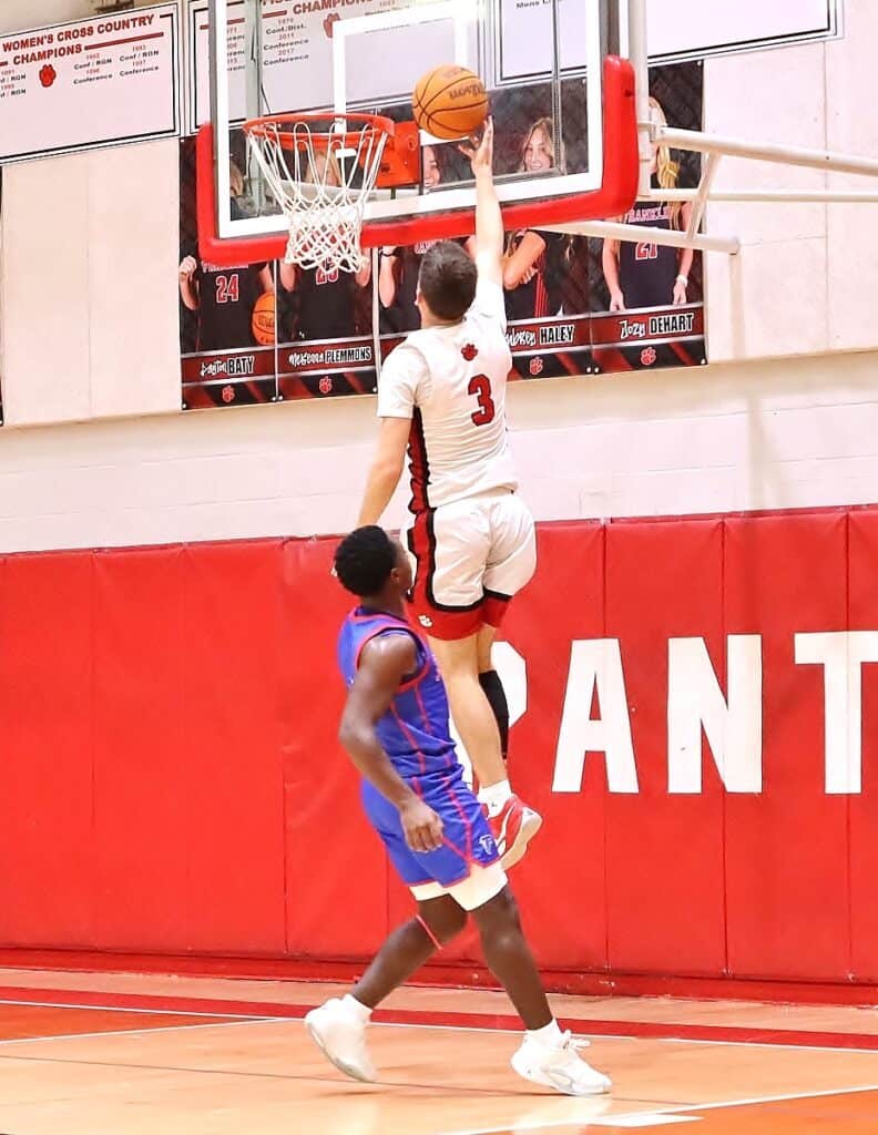 Franklin Panthers player dunking basketball during game.