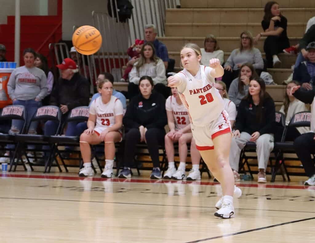 Franklin Panthers girl basketball player passing the ball during game.