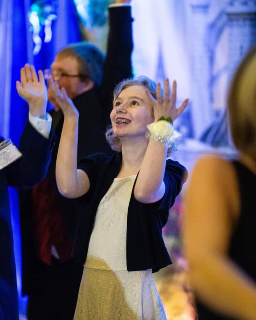 Joyful girl celebrating at Night to Shine event for special kings and queens.