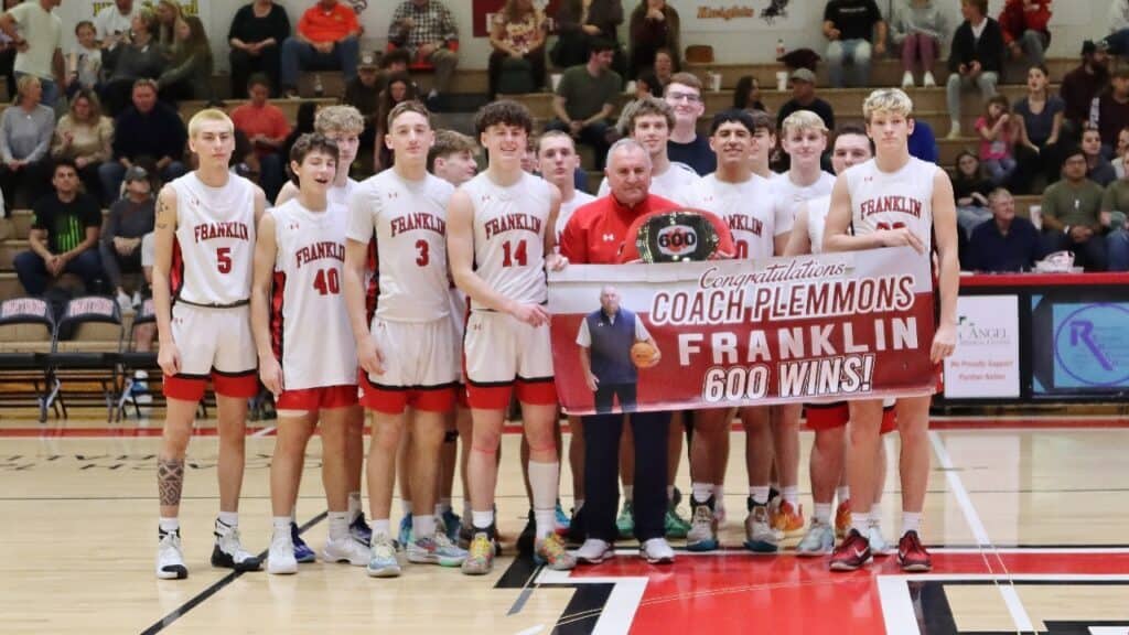 Franklin High School basketball team celebrating 600 wins with coach Plemons.