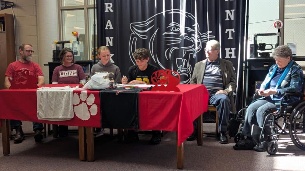 Young athletes signing letters of intent at FHS event.