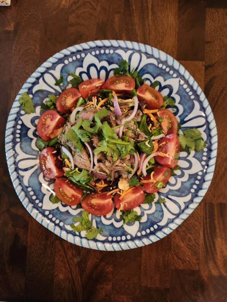 Healthy gluten-free low-carb salad with cherry tomatoes, red onions, and herbs, perfect for a tasty,.