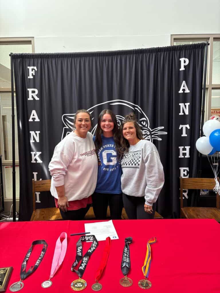 FHS student athletes signing with colleges at a recognition event.